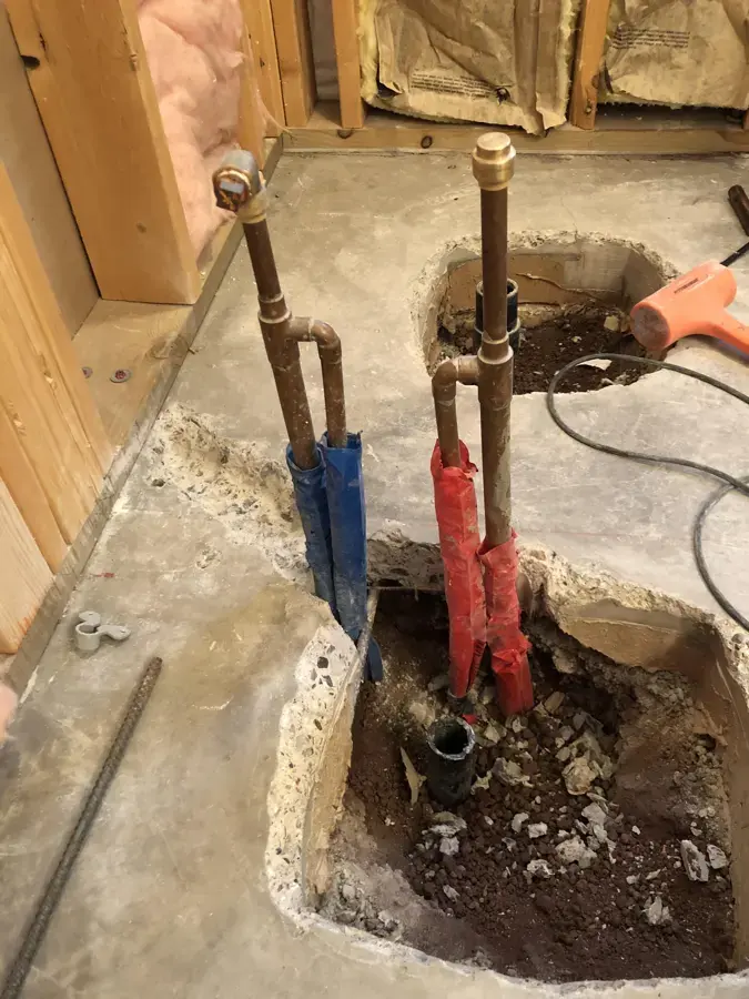 Copper water lines exposed in an opened concrete slab in a Temecula home
